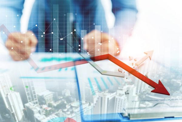 Businessman point at decreasing graph and increasing broken graph with city background